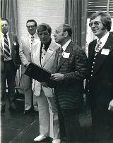 Rep. Annunzio speaks at the Annex II opening; board members Bob Kelly and Ed Kellaher look on.