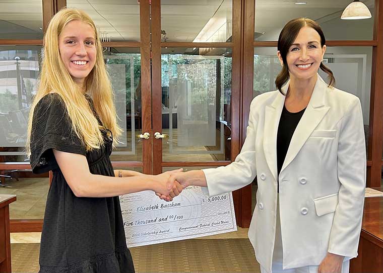 Elizabeth Bassham with $5,000 check